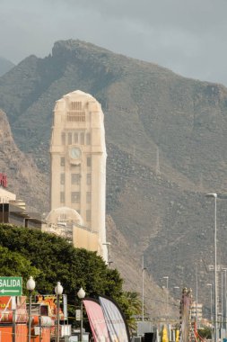 Santa Cruz de Tenerife, Tenerife, Spain - February 03, 2024: Medieval tower with bell and clock covered with mesh under renovation in Tenerife clipart