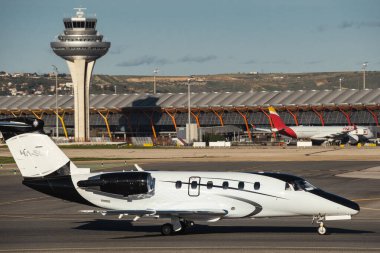 Madrid, Spain - February 02, 2024: Luxury Cessna 650 Citation VI business jet aircraft of JetStream Airlines with black and white livery taxing in Madrid-Barajas Airport during sunny day clipart