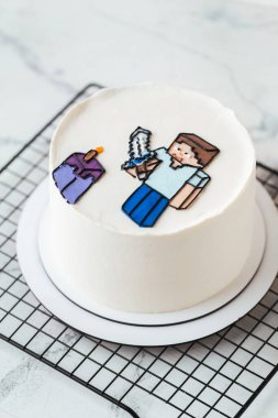 Kyiv, Ukrayna - 19 Nisan 2025: Beyaz mermer arka planda bir Minecraft oyunu hayranı için doğum günü pastası. Yenilebilir Minecraft karakterleriyle dekore edilmiş bir Gameboy için pasta.