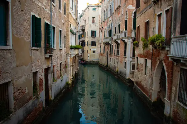 stock image  Calm water flowing through a Venetian canal lined with old, rustic buildings.