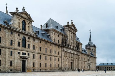 San Lorenzo de El Escorial, Spain - October 25, 2020: Royal Monastery of San Lorenzo de El Escorial near Madrid. Cloudy and foggy winter day
