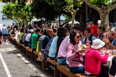 Ponta Delgada, Portugal - July 9, 2023: Ethnographic parade during Holy Spirit Festival. Traditional holidays in Azores. Lunch
