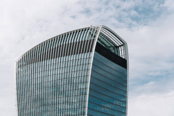 London, UK - August 25, 2023: Low angle view of 20 Fenchurch Street commercial skyscraper or The Walkie-Talkie in the City of London. View against blue sky with white clouds with space for copy