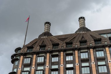 London, UK - August 26, 2023: Portcullis House in City of Westminster. Low angle view against cloudy sky clipart