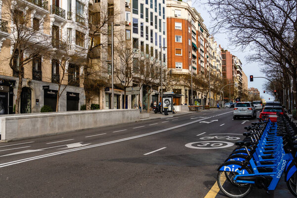 Madrid, Spain - 17 March, 2024: Ortega y Gasset Street in Salamanca District. Luxury Shopping area. Rental Bike parking