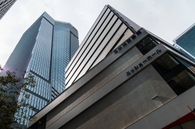 Tokyo, Japan - August 08, 2024: Low angle view of office buildings in Toranomon Hills area against sky. clipart