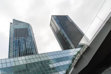 Tokyo, Japan - August 08, 2024: Low angle view of office buildings in Toranomon Hills area against sky. clipart