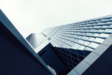 Tokyo, Japan - August 08, 2024: Low angle view of office buildings in Toranomon Hills area against sky. clipart