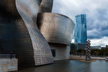 Bilbao, İspanya - 9 Ekim 2024: Nervion nehrinin kıyısında Frank Gehry tarafından inşa edilen Guggenheim Müzesi manzarası