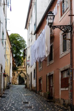 Lisbon, Portugal - October 29, 2022: A picturesque street in Alfama, Lisbon, with traditional architecture,and vibrant colors a rainy day