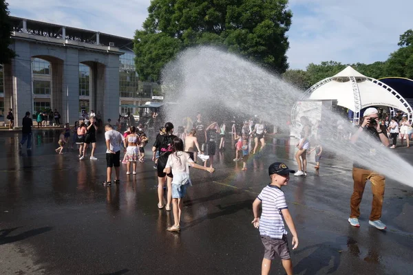 stock image Odessa Ukraine July 2 2023 Children have fun under water from a fire engine with a hot summer day