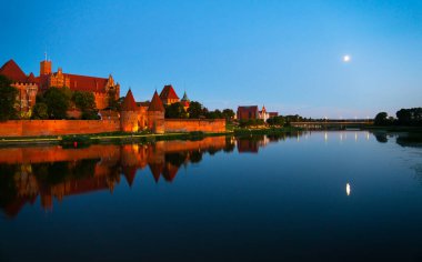 Marienburg castle the largest medieval brick castle in the world in the city of Malbork evening view at night