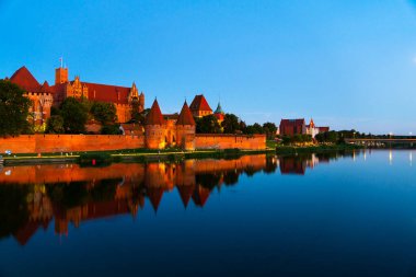 Marienburg castle the largest medieval brick castle in the world in the city of Malbork evening view at night
