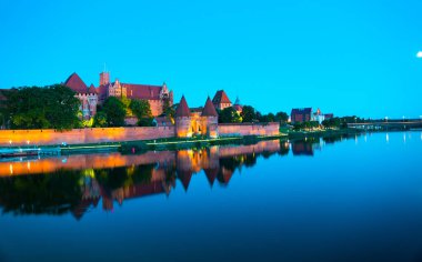 Marienburg castle the largest medieval brick castle in the world in the city of Malbork evening view at night