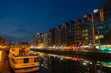 Scenic summer evening panorama of the architectural evening street of the Old Town embankment port Baltic GDANSK, POLAND - July 6, 2022