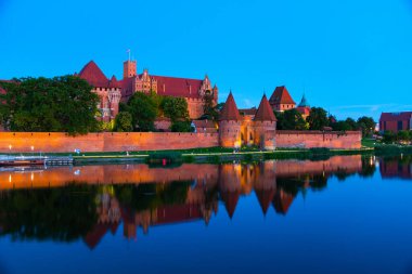 Marienburg castle the largest medieval brick castle in the world in the city of Malbork evening view at night