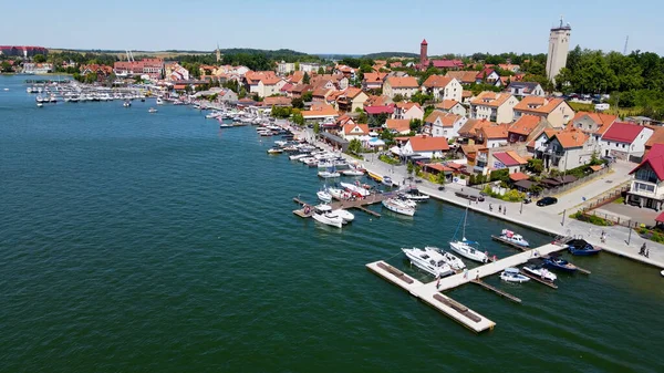 stock image Panoramic aerial photo from drone to Mikolajki townscape - capital of Masurian region on the shore of the holiday resort beautiful summer afternoon. Mikolajki, Poland, Europe.