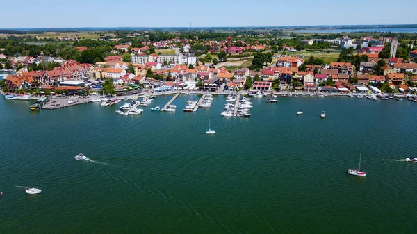 stock image Panoramic aerial photo from drone to Mikolajki townscape - capital of Masurian region on the shore of the holiday resort beautiful summer afternoon. Mikolajki, Poland, Europe.