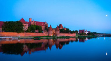 Marienburg castle the largest medieval brick castle in the world in the city of Malbork evening view at night