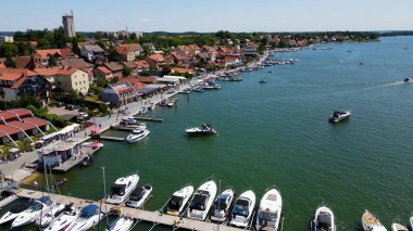 Panoramic aerial photo from drone to Mikolajki townscape - capital of Masurian region on the shore of the holiday resort beautiful summer afternoon. Mikoajki, Poland, Europe. clipart