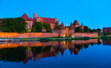 Marienburg castle the largest medieval brick castle in the world in the city of Malbork evening view at night