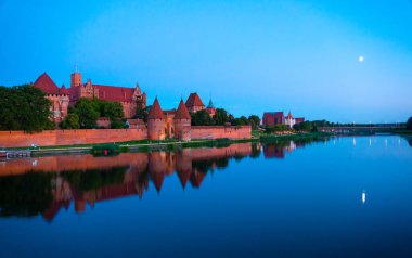 Marienburg castle the largest medieval brick castle in the world in the city of Malbork evening view at night