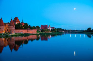 Marienburg castle the largest medieval brick castle in the world in the city of Malbork evening view at night