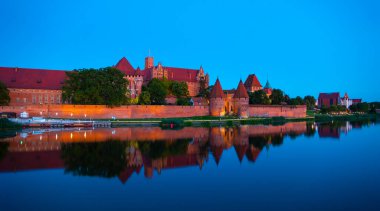 Marienburg castle the largest medieval brick castle in the world in the city of Malbork evening view at night
