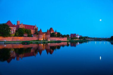 Marienburg castle the largest medieval brick castle in the world in the city of Malbork evening view at night