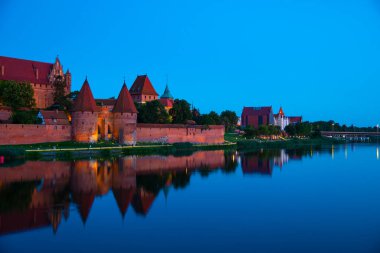 Marienburg castle the largest medieval brick castle in the world in the city of Malbork evening view at night