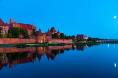 Marienburg castle the largest medieval brick castle in the world in the city of Malbork evening view at night