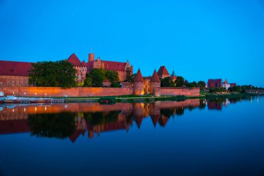 Marienburg castle the largest medieval brick castle in the world in the city of Malbork evening view at night