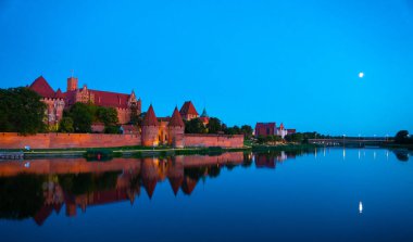 Marienburg castle the largest medieval brick castle in the world in the city of Malbork evening view at night