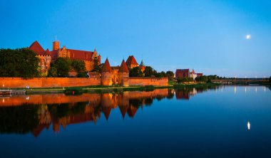 Marienburg castle the largest medieval brick castle in the world in the city of Malbork evening view at night
