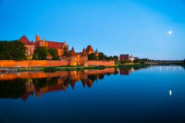 Marienburg castle the largest medieval brick castle in the world in the city of Malbork evening view at night