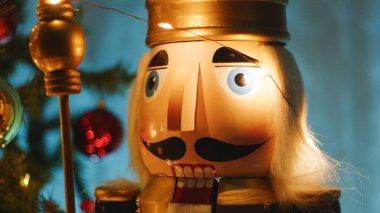 Geceleyin altın ve kırmızı topları olan Noel ağacı ve fındıkkıran.