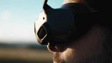 Man with virtual reality goggle drive the fpv drone.