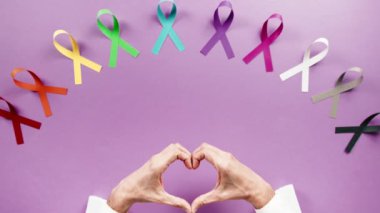 Bow symbol for world cancer day background overhead view