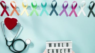 Bow symbol for world cancer day background overhead view