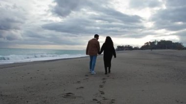 Romantic Couple Walk Together On Beach.