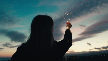 silhouette of Girl with Heart symbol in the sky.