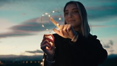 silhouette of Girl with Heart symbol in the sky.