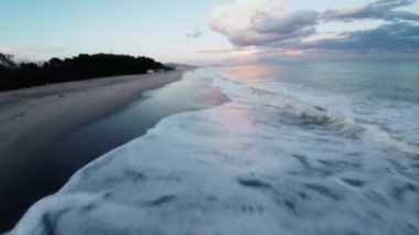 Ocean water with winter clouds in evening sky aerial view