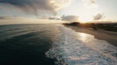 Ocean water with winter clouds in evening sky aerial view