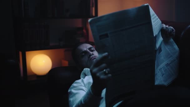 Businessman Lying Sofa Reads Newspaper Night — Stock Video