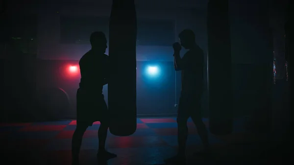Boxing gym with red and blue lights.