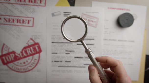 Magnifying Glass Shows Very Confidential Personal Documents — Stock Video