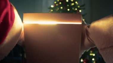 Noel Baba ağacın altında sihirli bir Noel kutusu teslim ediyor. . 