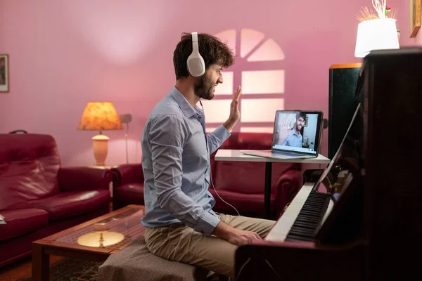 Man Teaching Piano Lesson With Remote Video Streaming.