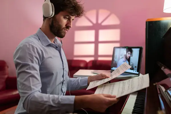 Man Teaching Piano Lesson With Remote Video Streaming.